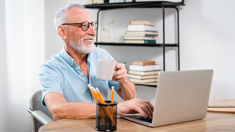 A older man sat at a computer wondering "Can anyone have lens replacement?"